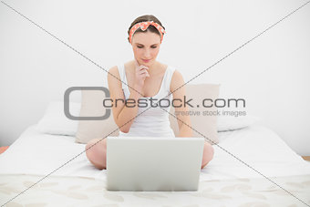 Thinking woman working with her notebook