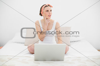 Woman working with her notebook looking up