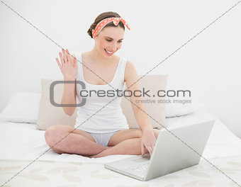 Young woman video chatting with her notebook