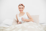 Smiling woman lying in her bed