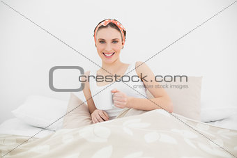 Smiling woman lying in her bed