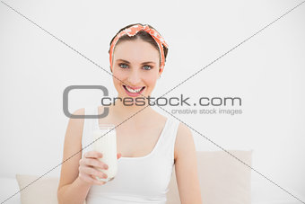 Smiling woman holding a glass of milk