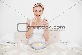 Smiling woman eating popcorn