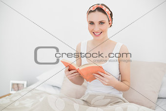 Smiling woman holding a book
