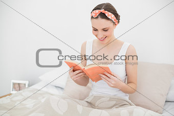 Smiling woman reading a book