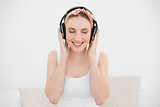 Woman wearing headphones with closed eyes