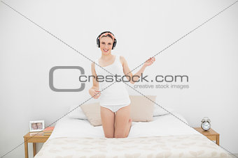 Woman playing air guitar while listening to music