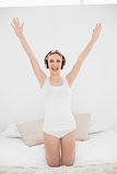 Woman raising her arms while listening to music