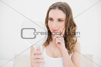 Young woman looking into a mirror