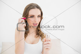Pretty woman using mascara