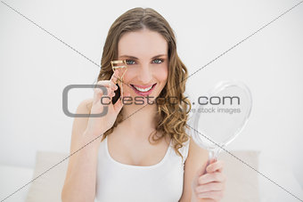 Woman using an eyelash curler