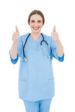 Woman doctor putting her thumbs up
