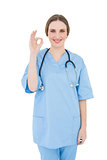 Woman doctor giving a signal that everything is fine