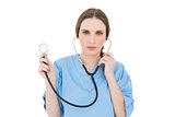 Young woman doctor holding a stethoscope
