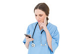 Pretty woman doctor using her smartphone