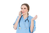 Young woman doctor phoning