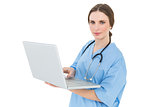 Young female doctor working with her notebook and looking into the camera