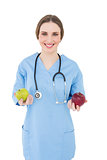 Female doctor holding two apples