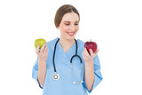 Young woman doctor keeping two apples