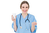 Female doctor holding a plastic cup and presenting with her hand