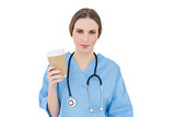 Young female doctor holding a coffee mug