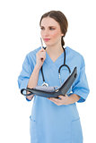 Thoughtful female doctor holding a file