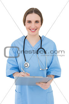 Young female doctor working with her clipboard