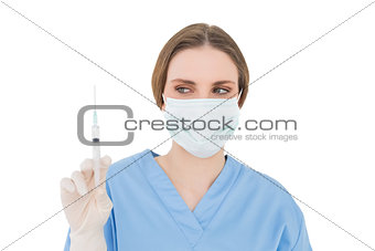Young brunette female doctor holding a syringe