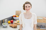 Attractive brunette woman posing in her kitchen