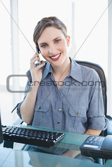 Friendly businesswoman phoning with her smartphone