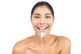 Cheerful nude brunette holding toothbrush