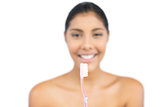Happy nude brunette holding toothbrush