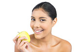 Smiling nude brunette holding green apple