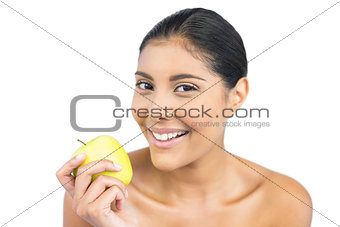 Smiling nude brunette holding green apple