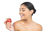 Happy nude brunette holding red apple