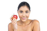 Pleased nude brunette holding red apple