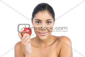 Pleased nude brunette holding red apple