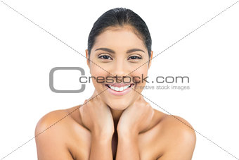 Smiling nude brunette holding her neck