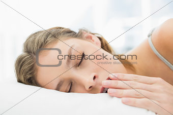 Pretty calm woman lying in her bed yawning