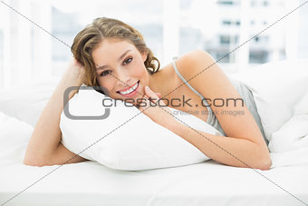Peaceful content woman lying in her bed under the cover