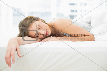 Peaceful napping woman lying in her bed