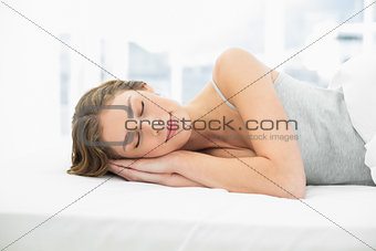Calm sleeping woman lying in her bed