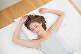 Calm woman sleeping while lying on her bed under he cover