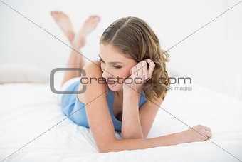 Content beautiful woman lying on her bed