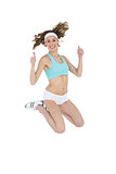 Cheerful sporty woman jumping showing thumbs up