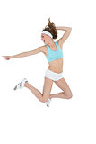 Attractive sporty woman jumping while pointing