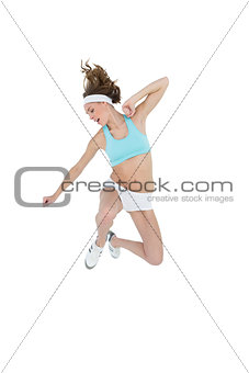 Sporty slender woman wearing sportswear jumping