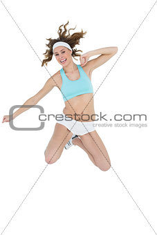 Content young woman wearing sportswear jumping smiling at camera