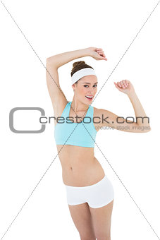 Attractive slim woman wearing sportswear dancing looking at camera