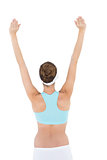 Rear view of brunette woman raising her arms wearing sportswear